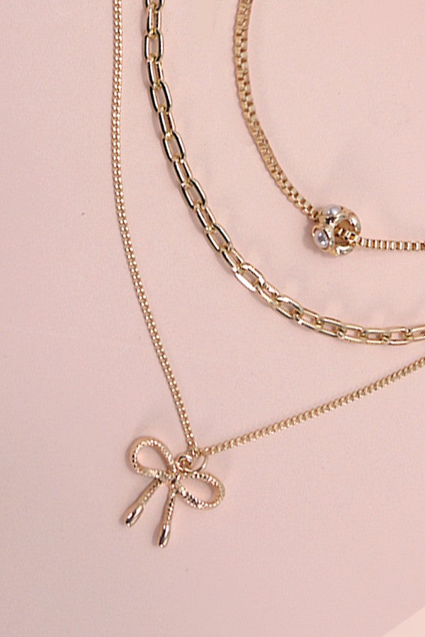 BOW MULTI LAYER PEARL BOW CAHRM NECKLACE